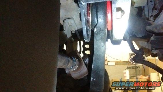 Close-up of a vehicle's driveshaft and suspension components, possibly from a Ford Bronco