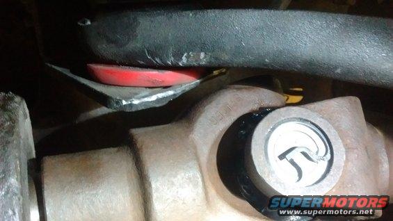 Driveshaft U-joint with red suspension bushing and black bar above