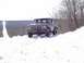 1979 Ford Bronco - A maroon Ford Bronco navigates a snow-covered incline on a bright, clear day.