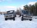 1979 Ford Bronco - Two modified trucks navigate a snowy path, one appearing to be a 1970s Ford F-series and the other a Ford Bronco.