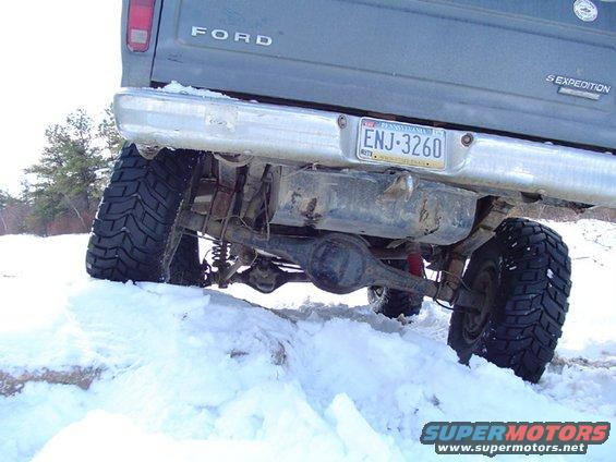 Rear view of Ford Expedition in snow, showing large tires and suspension