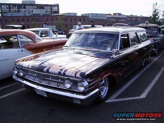 Black station wagon with flame graphics, chrome grille, and lowered suspension