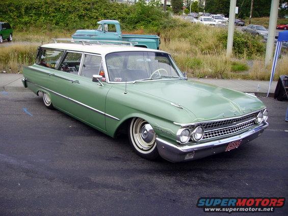 Green 1959 station wagon with a white roof, lowered suspension, and whitewall tires