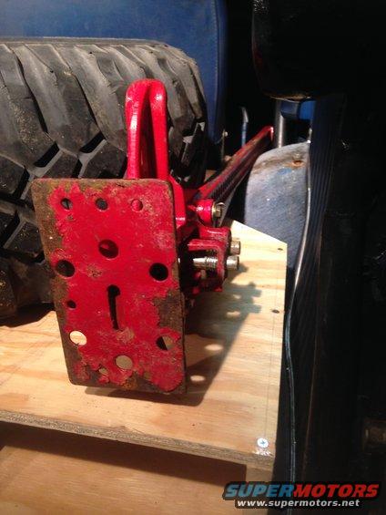 Red hi-lift jack and tire inside a vehicle