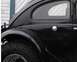 1964 Volkswagen Beetle - A close-up shot captures the side profile of a classic black automobile, highlighting its unique design elements.