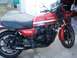 2008 Ford Crown Victoria - A red Kawasaki GP1100 motorcycle is parked in front of a garage door.