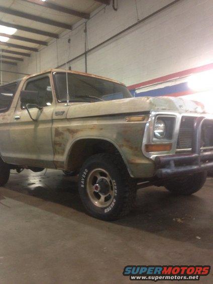 1978 Ford Bronco with rust damage, parked indoors