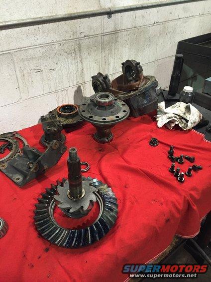 Differential gears and components laid out on a red cloth
