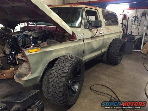 1978 Ford Bronco in garage, hood open, showing engine. Modified with large tires