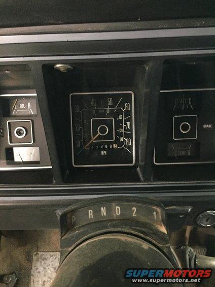 Dashboard gauges of a 1978 Ford Bronco, including speedometer, oil pressure, and temperature gauges