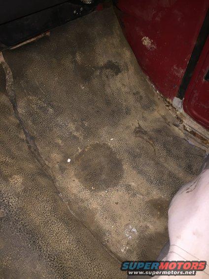 Interior floor mat with stains and wear