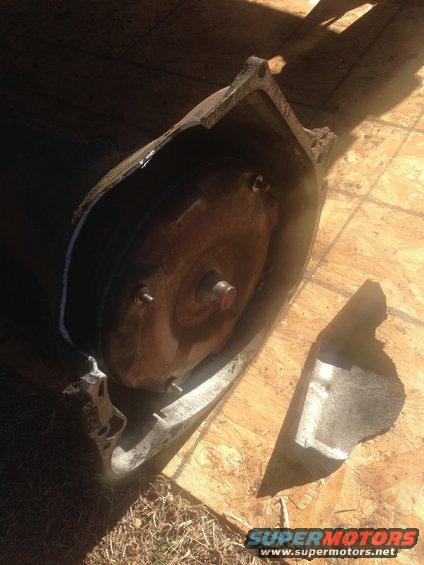 Damaged transmission torque converter on wooden surface
