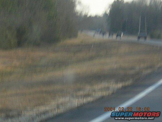 Several vehicles on a road, some appear to be SUVs or trucks
