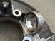 2003 Ford Taurus - A close-up view of a worn metal suspension part, possibly a control arm or knuckle, showing a bearing race.
