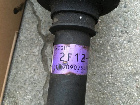 Purple label on automotive part reads RIGHT 2F12- 11090902521