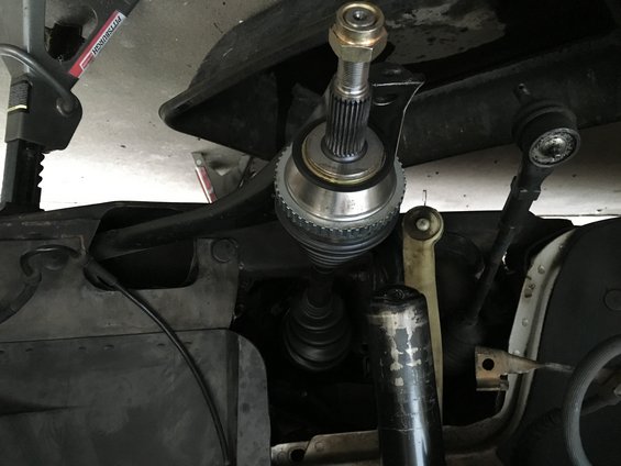 CV axle assembly and suspension parts under a vehicle, supported by a jack