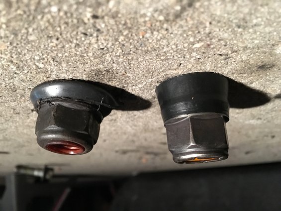 Two bolts with rubber grommets protruding from concrete