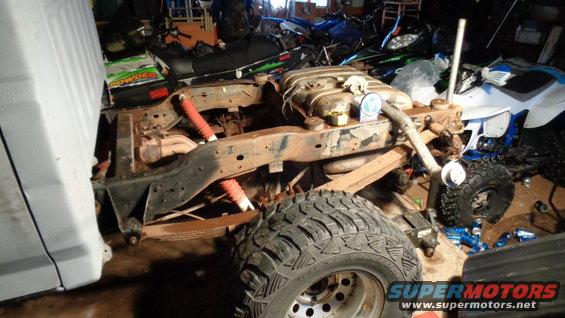Rear suspension and frame of a vehicle with red shocks and leaf springs