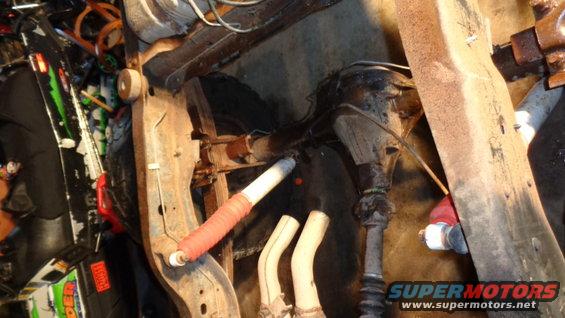 Close-up of vehicle suspension parts including a shock absorber and differential