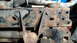 1985 Ford Bronco - Close-up view of heavily rusted vehicle frame components and suspension parts.