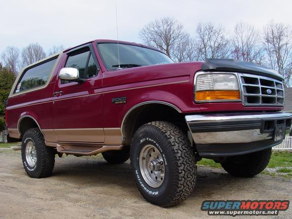 Maroon 1995 Ford Bronco 3/4 front view with tan trim and off-road tires