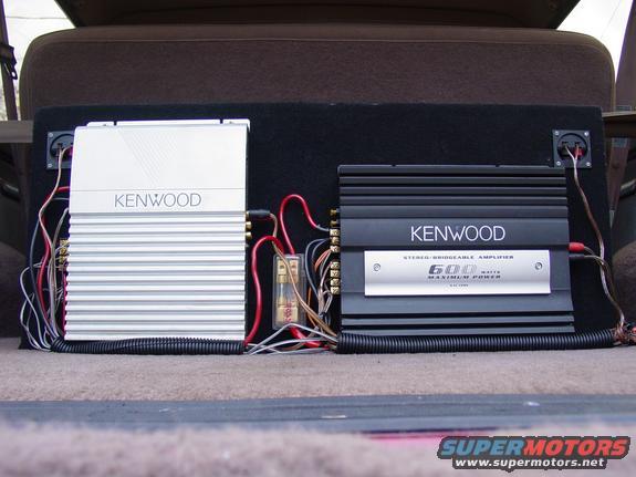 Two Kenwood amplifiers, one silver and one black, wired together