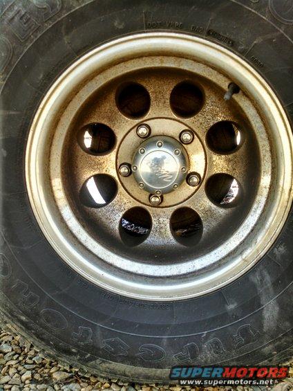 Close-up of a rusty wheel with a tire