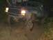 1978 Ford Bronco - Muddy Jeep Cherokee XJ navigating a difficult off-road path.