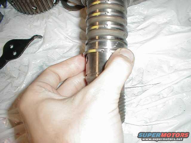 There are 6 sealing rings on the output shaft to replace... 2 orange (not shown) and 4 teflon (shown)