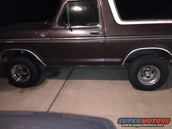 Side view of a brown 1978 Ford Bronco with a white top