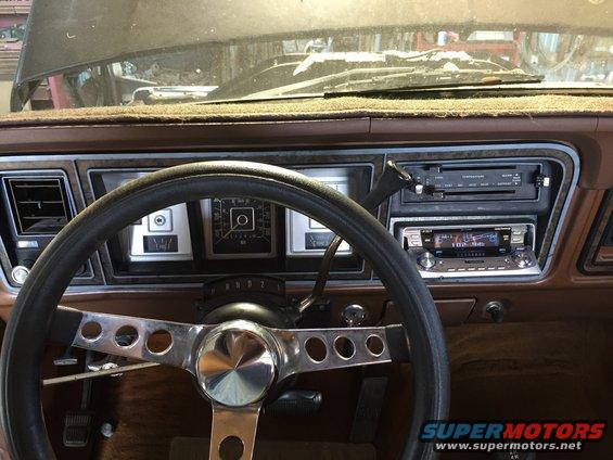 1978 Ford Bronco interior dashboard with aftermarket stereo and custom steering wheel
