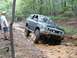 1978 Ford Bronco - This Toyota 4Runner is tackling a challenging muddy trail with its lifted suspension.