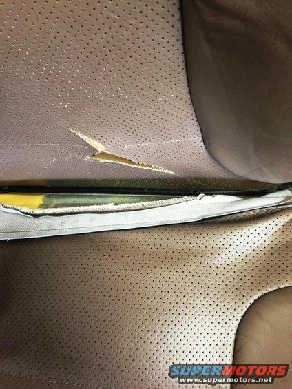 Torn leather seat interior with visible foam padding