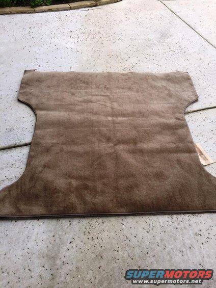 Brown carpet piece laid out on concrete
