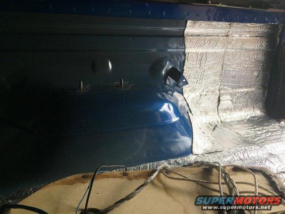 Back of vehicle with sound deadening material installed on the side panel