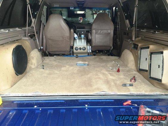 1996 Ford Bronco interior, tan carpet, brown seats, subwoofer box, blue tailgate
