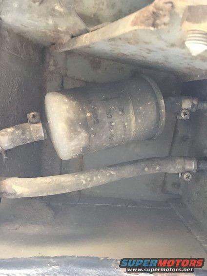 Fuel filter with white residue, attached to hoses and vehicle undercarriage