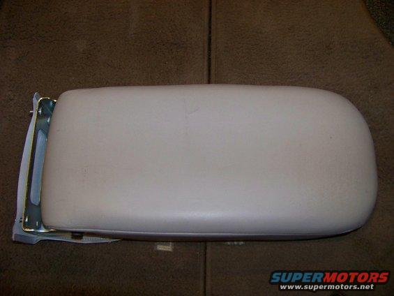 Beige armrest with metal bracket attached, viewed from above