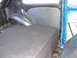 1964 Volkswagen Beetle - The interior of a blue vehicle shows a custom platform and paneling.