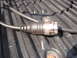 1964 Volkswagen Beetle - A close-up view of an electrical connector and cable resting on a textured surface.