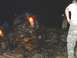 1978 Ford Bronco - Off-road vehicle stuck on rocks at night, with people standing nearby.