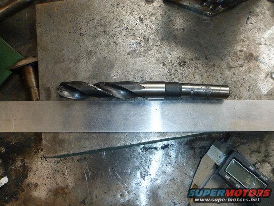 Drill bit on metal surface with calipers