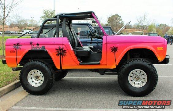1978 Ford Bronco with sunset gradient paint and palm tree decals. Another Bronco is parked behind it
