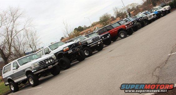 Silver and gray Ford Bronco parked in a lot, front 3/4 view