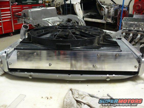 Radiator and electric fan assembly with aluminum shroud, in a workshop setting