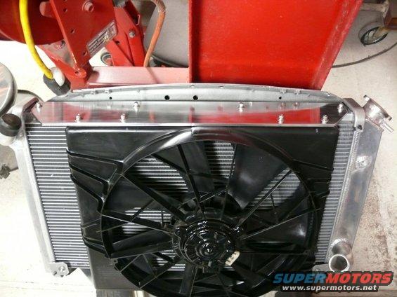 radiator with electric fan mounted in front, attached to red metal frame