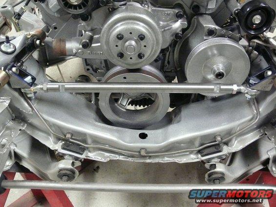 Engine bay with pulleys and frame components