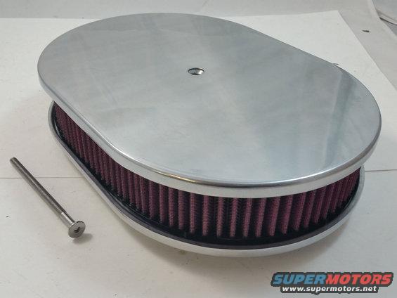 oval air cleaner with red filter element and chrome lid, next to a bolt