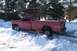 1988 Chevrolet Silverado 2500 - This red pickup truck is stuck in a snowy area, showing its side profile and 4x4 badging.