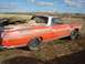 1971 Ford Ranchero - This weathered Ford Ranchero is parked outdoors, carrying lumber and spare tires in its bed.
